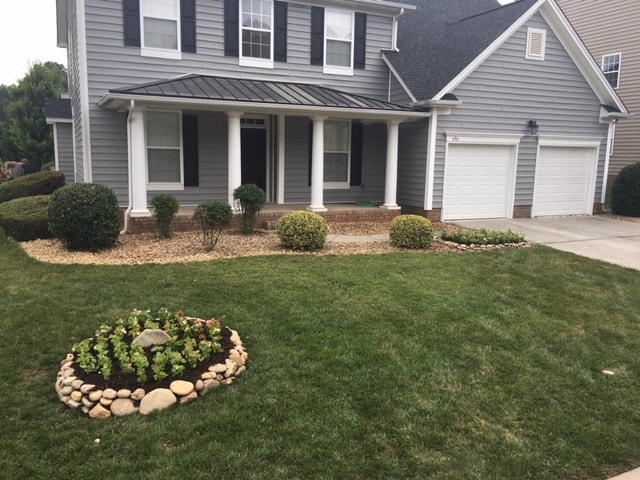 Manicured front yard with landscape beds