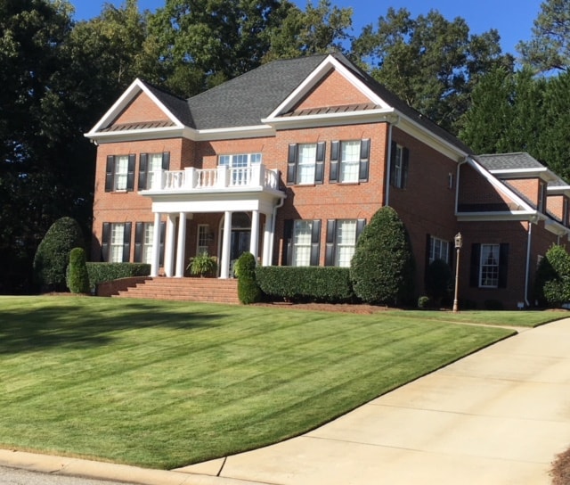 Pristine lawn at a large brick home